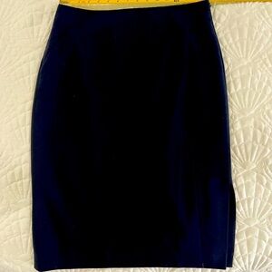 Navy pencil skirt with left waist zip and left side slit.